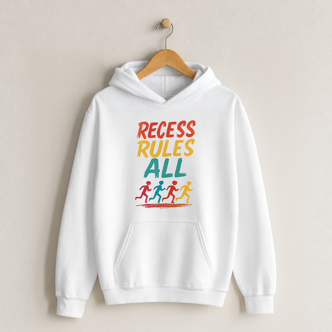 Recess Rules All – Kids Classic Hoodie Sweatshirt on a wooden hanger and wall peg, with a naturally collapsed hood