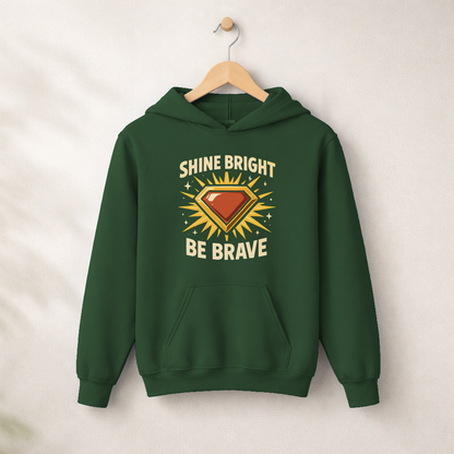 Shine Bright Be Brave – Kids Classic Hoodie Sweatshirt on a wooden hanger and wall peg